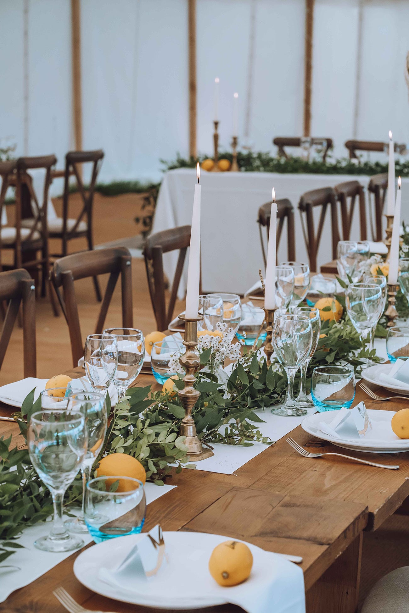 The stunning table setting with decorations of lemons and greenery