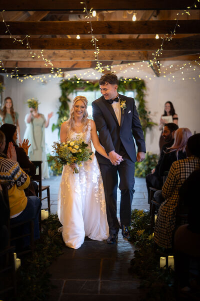 Bride and Groom walking down the aisle