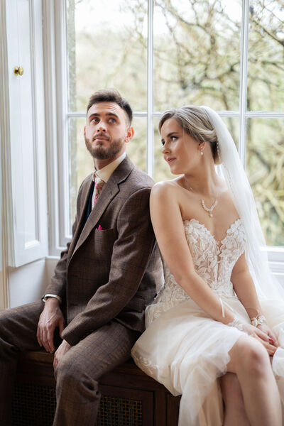 Bride and Groom sitting in a window seat
