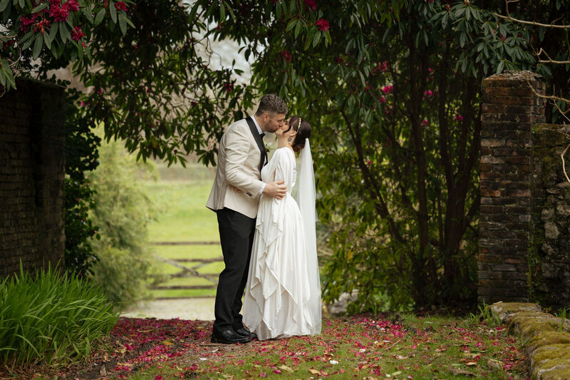 Bride and Groom Kissing in a woodland