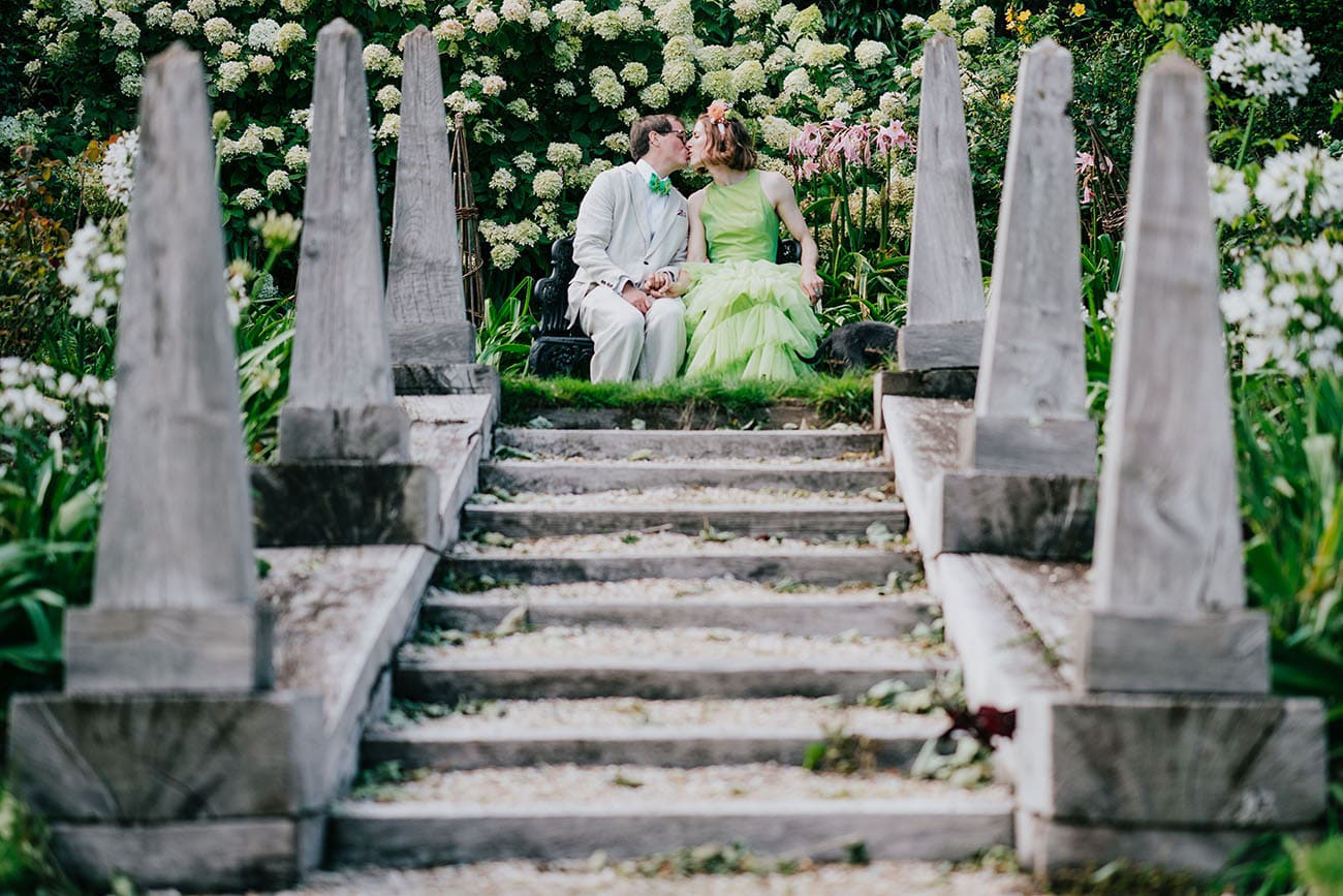 Bride and groom kiss in the wedding venue's beautiful gardens