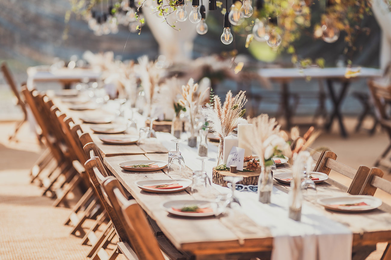 Wooden trestle tables for wedding reception set out for dining 
