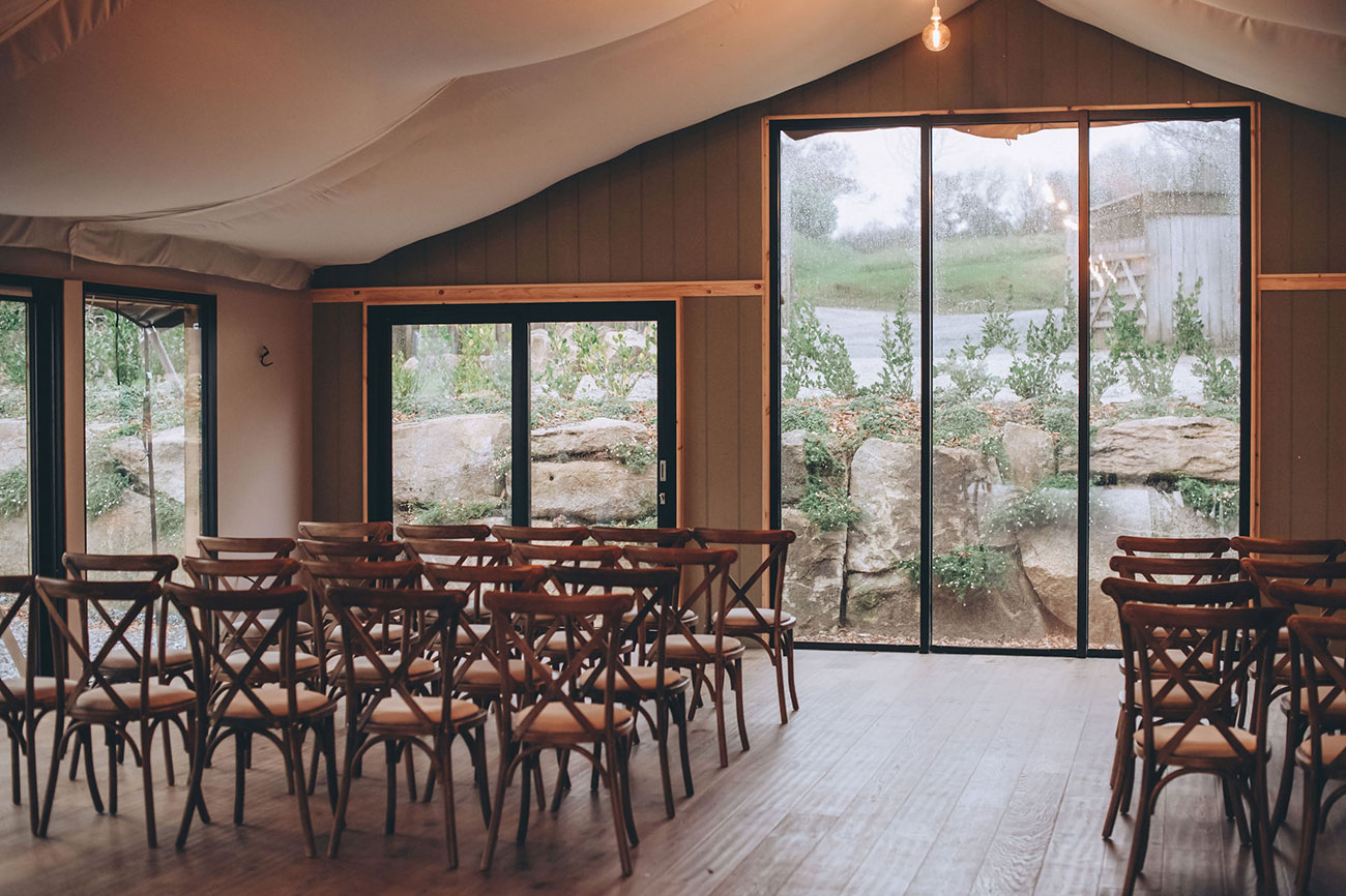 Ceremony room with wooden chairs and views of the garden